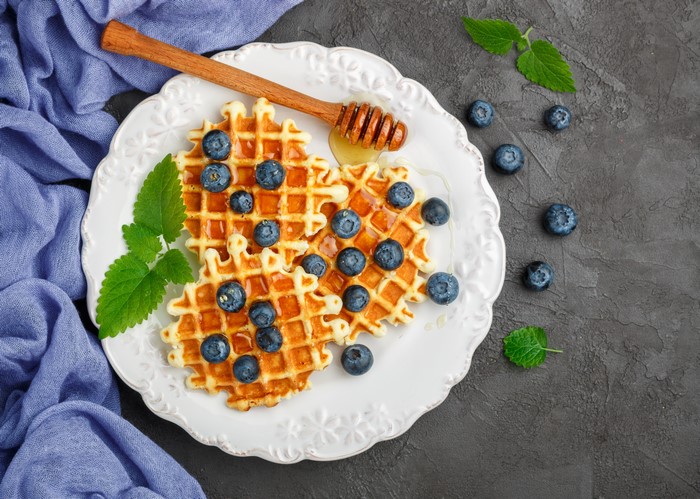 Waffles with blueberries and honey on a plate