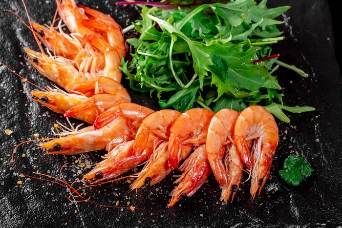 Cooked Shrimp with Salad on Dark Surface