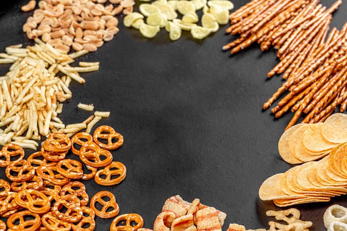 Assortment of salty snacks including pretzels, chips, and fries