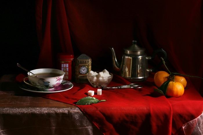Still life with tea set, oranges, and sugar cubes