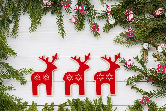 Christmas deer and fir branches on wood planks