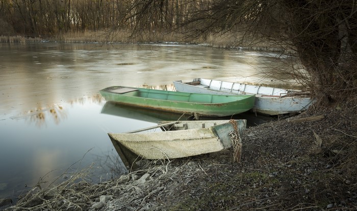 Boats on a partially frozen lake