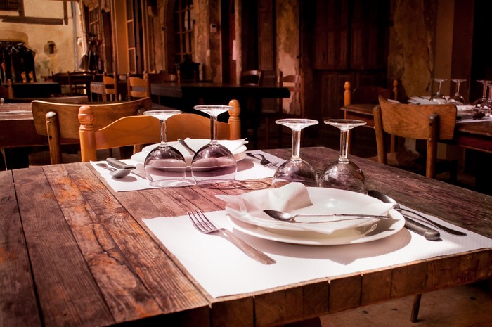 Restaurant table setting with wine glasses and plates