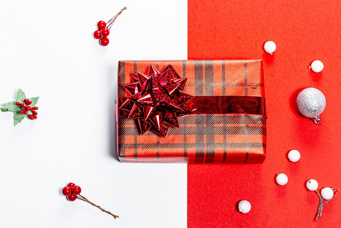 Christmas gift with berries and ornaments