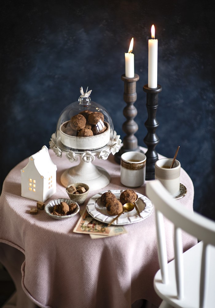 Candles and chocolate truffles on a table