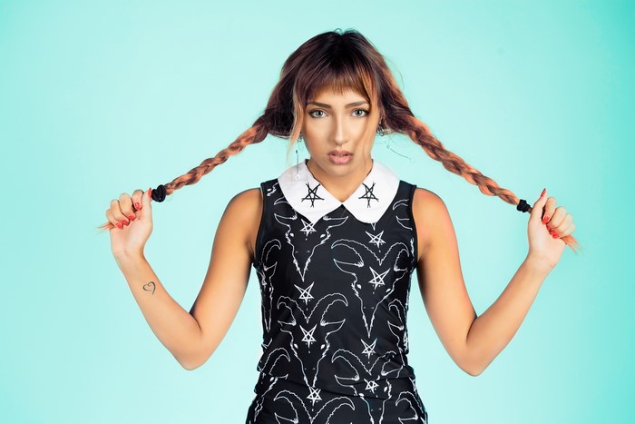 Woman with braided hair wearing a black dress