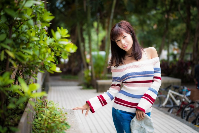 Asian woman with brown hair posing outdoors