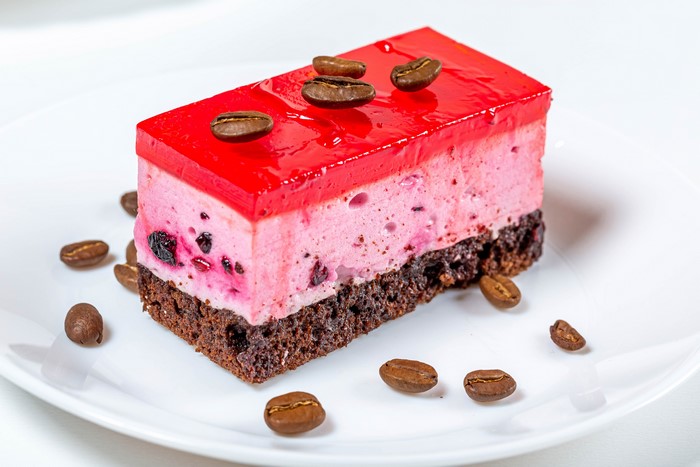 Slice of layered cake with coffee beans