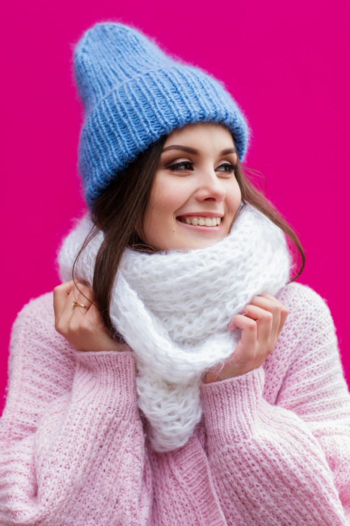 Woman in winter hat and sweater smiling