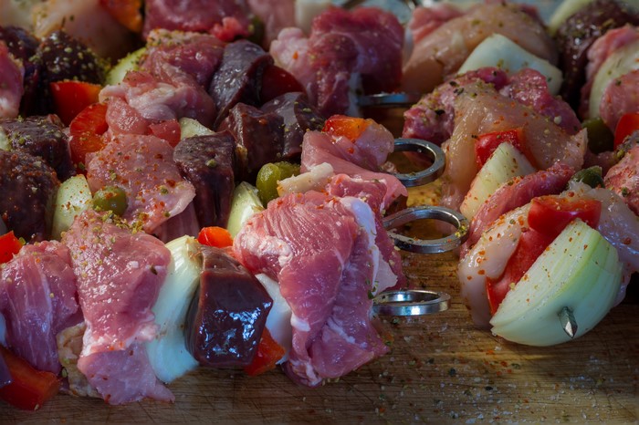 Raw meat and vegetable skewers seasoned with spices