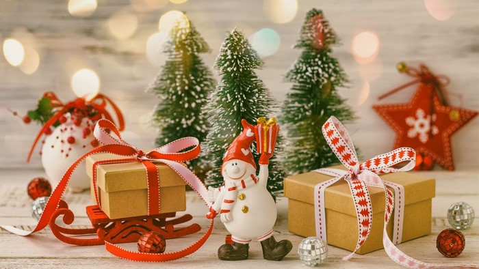 Christmas scene with gifts, trees, and a snowman