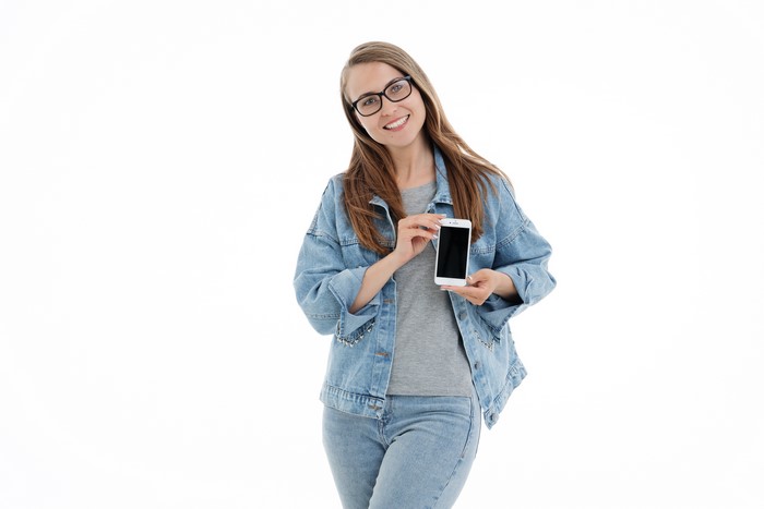 Woman in Denim Jacket Holding Smartphone