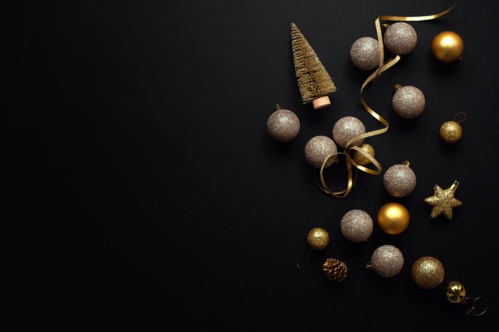 Christmas ornaments and tree on black background