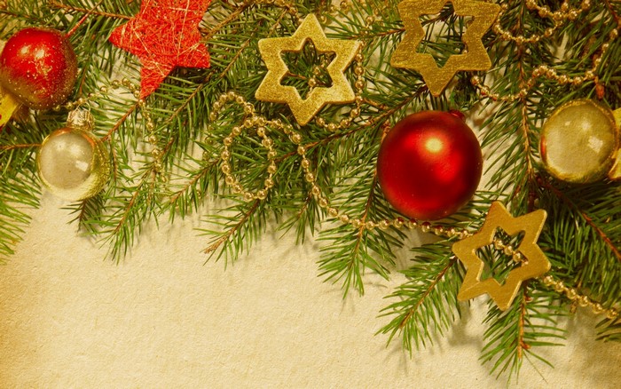 Christmas tree branches with ornaments and stars
