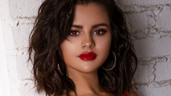 Selena Gomez with red lips and brown hair