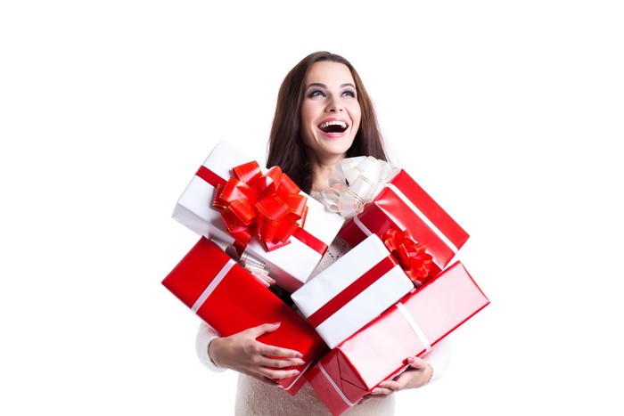 Woman holding many Christmas gifts
