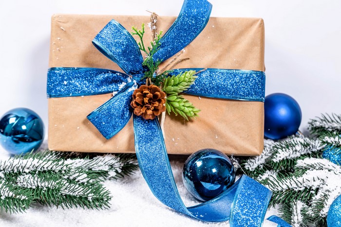 Christmas gift with blue ribbon and ornaments