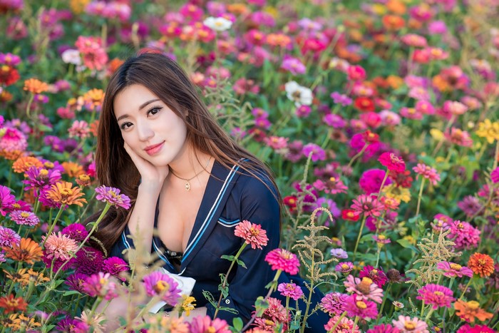 Asian Woman Among Vibrant Flowers