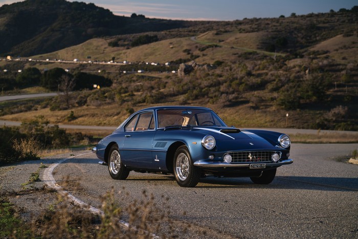 Blue Metallic Ferrari parked on a winding road