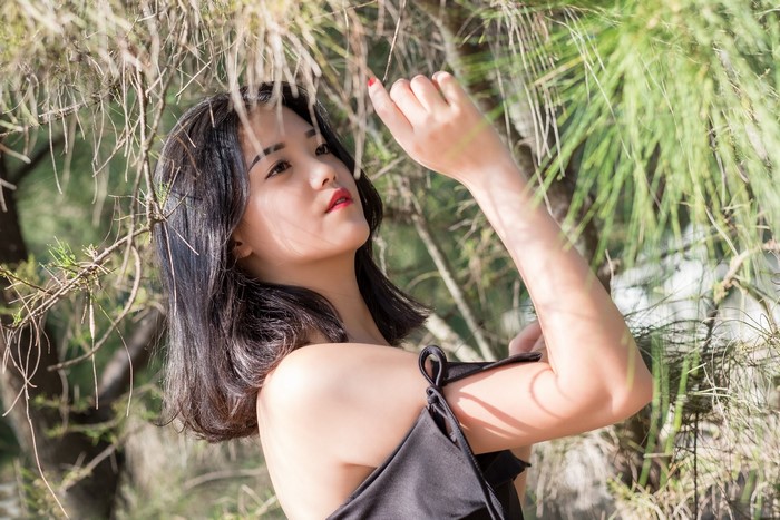 Brunette Asian Girl Among Greenery