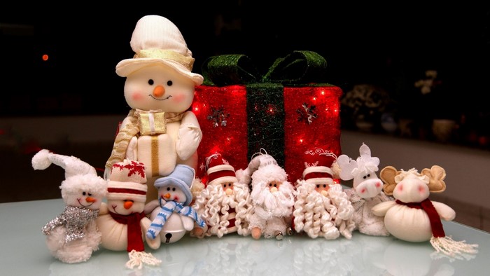 Christmas toys: Snowmen, Santas, and reindeer with a gift box