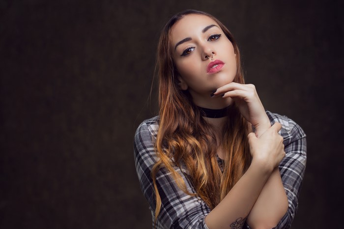 Woman with nose ring and plaid shirt