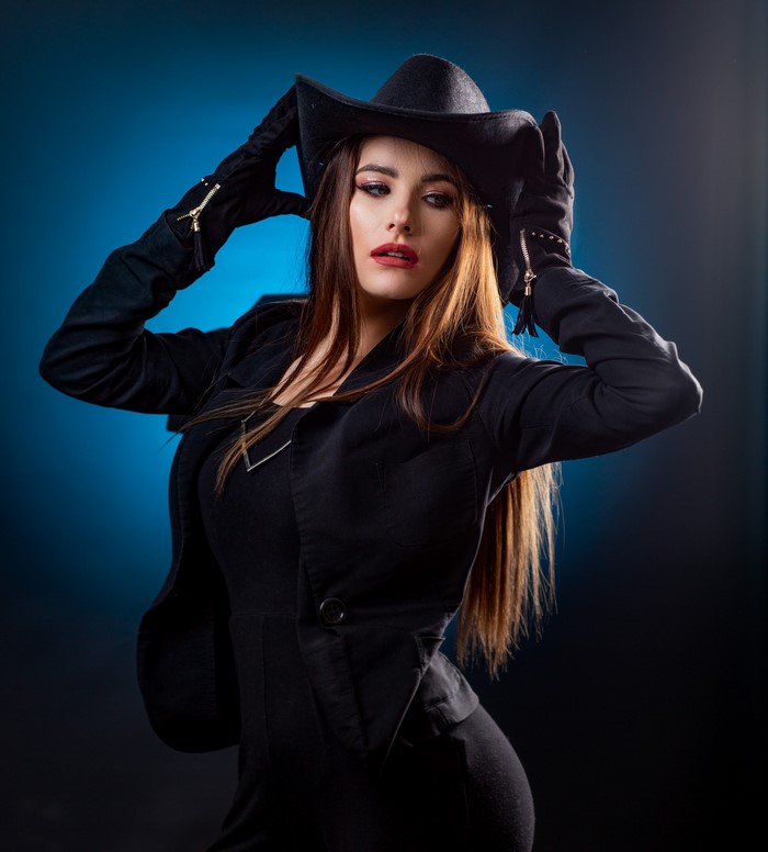 Woman in black jacket, hat, and gloves