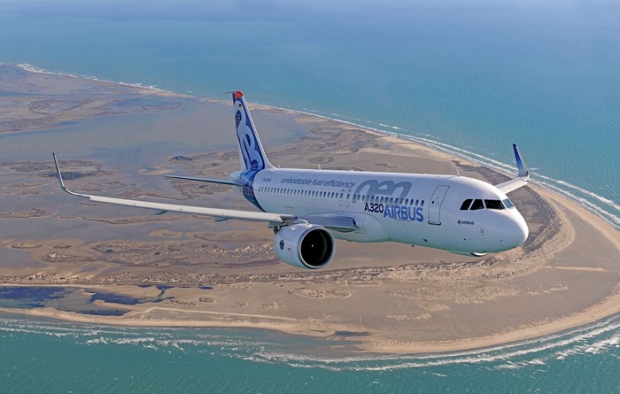 Airbus A320 aircraft flying over coastline