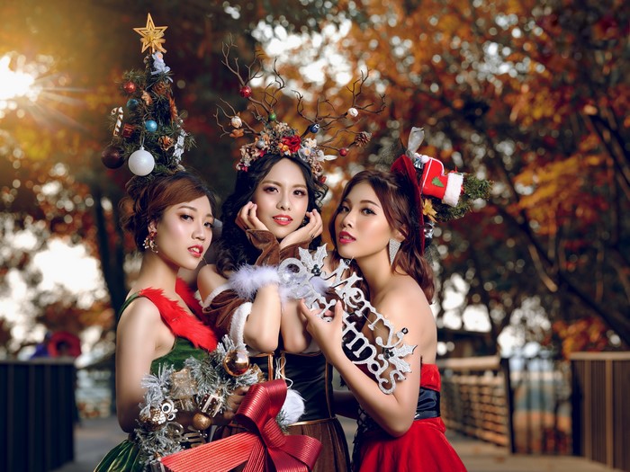 Three Asian women in Christmas outfits