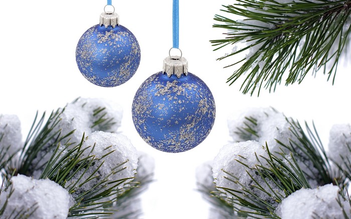 Two blue Christmas ornaments with snow on pine branches