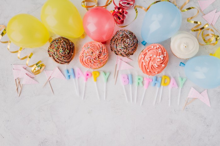 Birthday cupcakes with balloons and candles