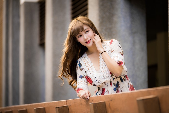 Asian woman with brown hair in a floral dress