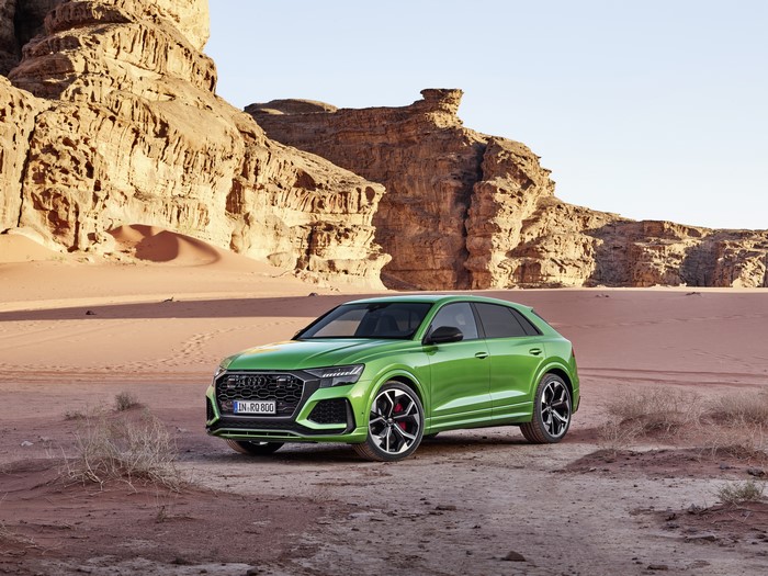 Green Audi RS Q8 in a desert landscape