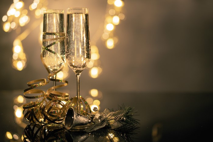 Champagne glasses with festive decorations and bokeh lights