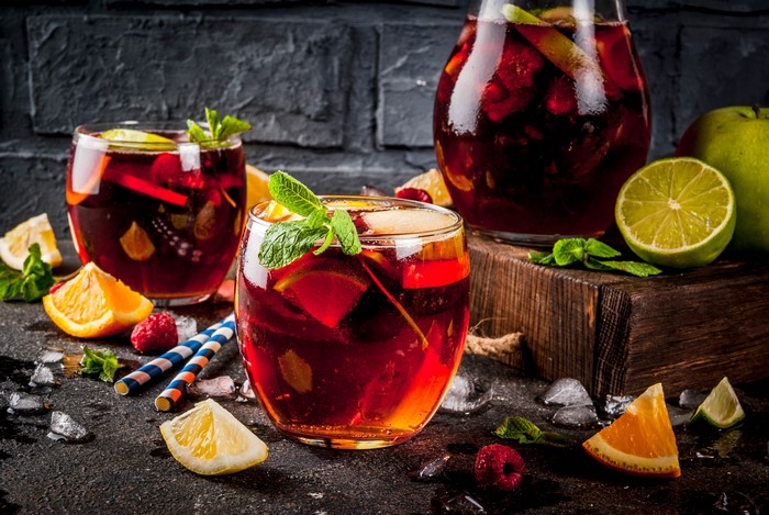 Sangria in glasses and jug with fruits