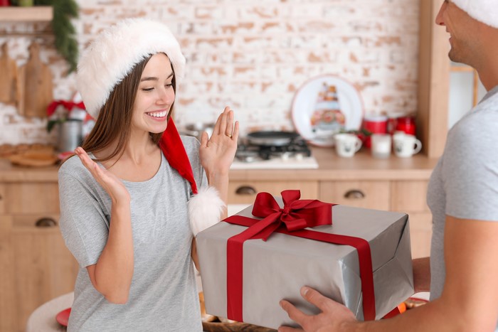 Woman in Santa Hat Receives Christmas Gift