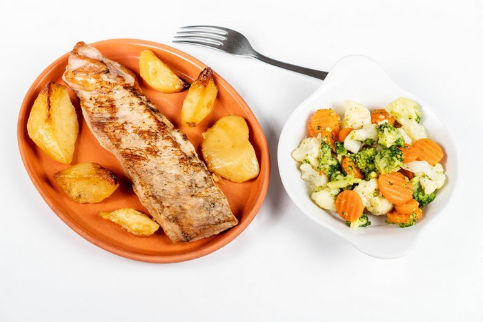 Grilled fish with roasted potatoes and mixed vegetables