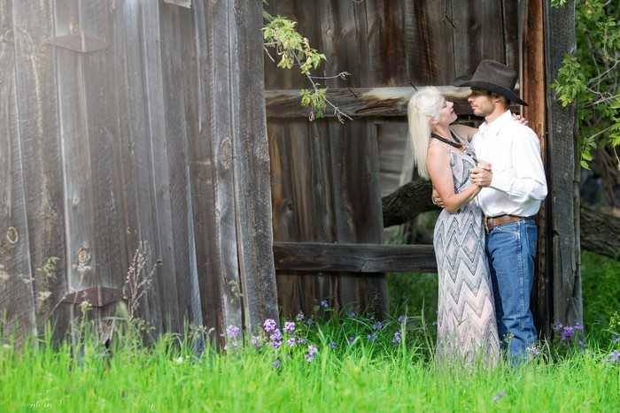 Couple dancing by old wooden building