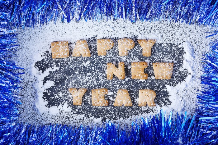 Happy New Year cookies with blue tinsel and snow