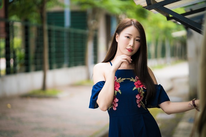 Asian woman in a blue dress with flowers