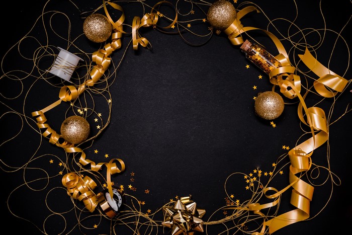 Gold Christmas decorations on a black background