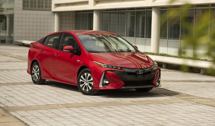 Red Toyota Prius parked on a paved area