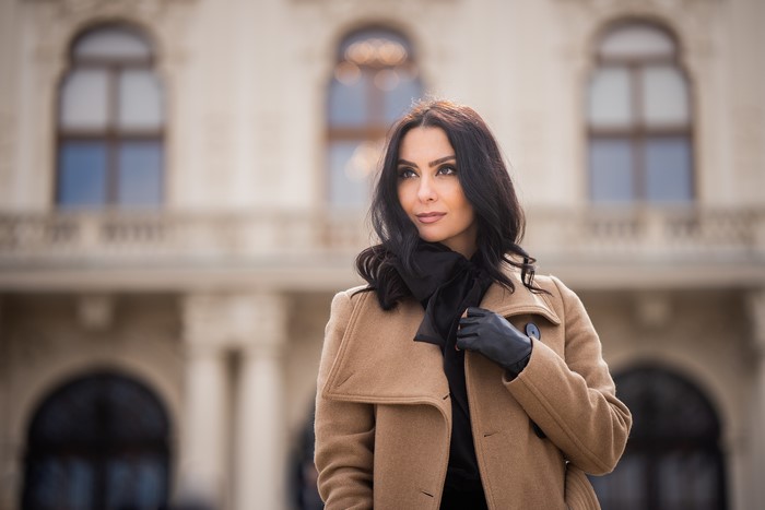 Brunette woman in coat and gloves