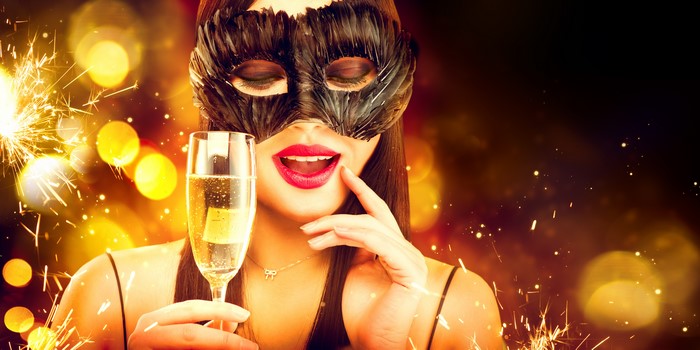Woman in Mask Holding Champagne with Sparklers