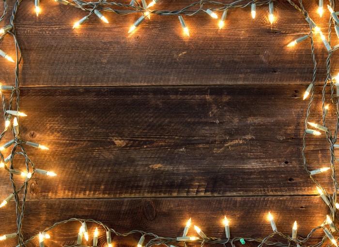 Christmas fairy lights on wood planks