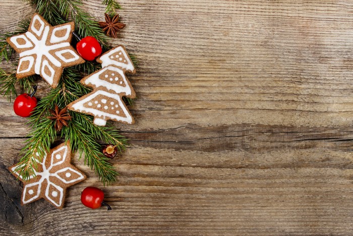 Christmas cookies with fir branches on wood