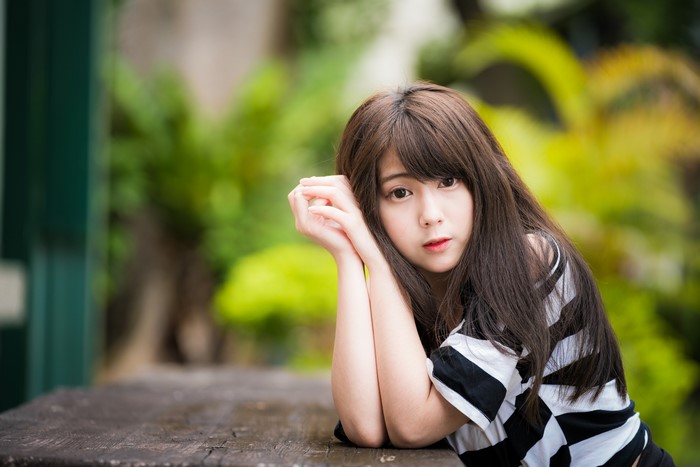 Cute Asian girl with brown hair and black and white shirt