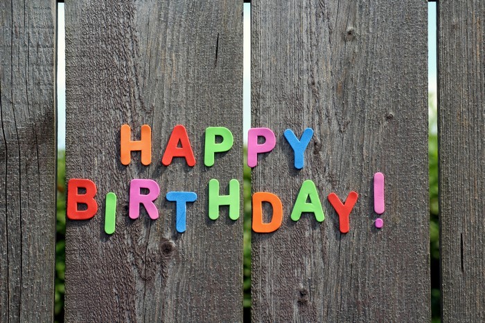 Happy Birthday text on wooden fence
