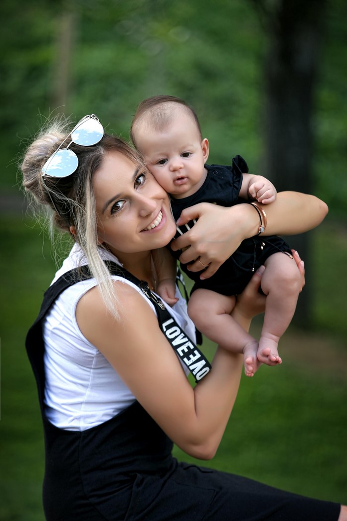Mother holding her baby outdoors