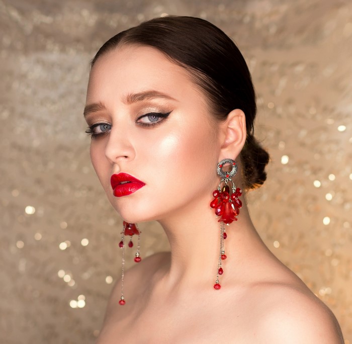 Woman with red lips and large red earrings